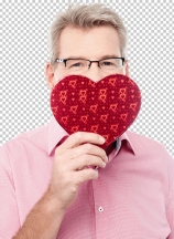 Mature man holding heart shaped gift box